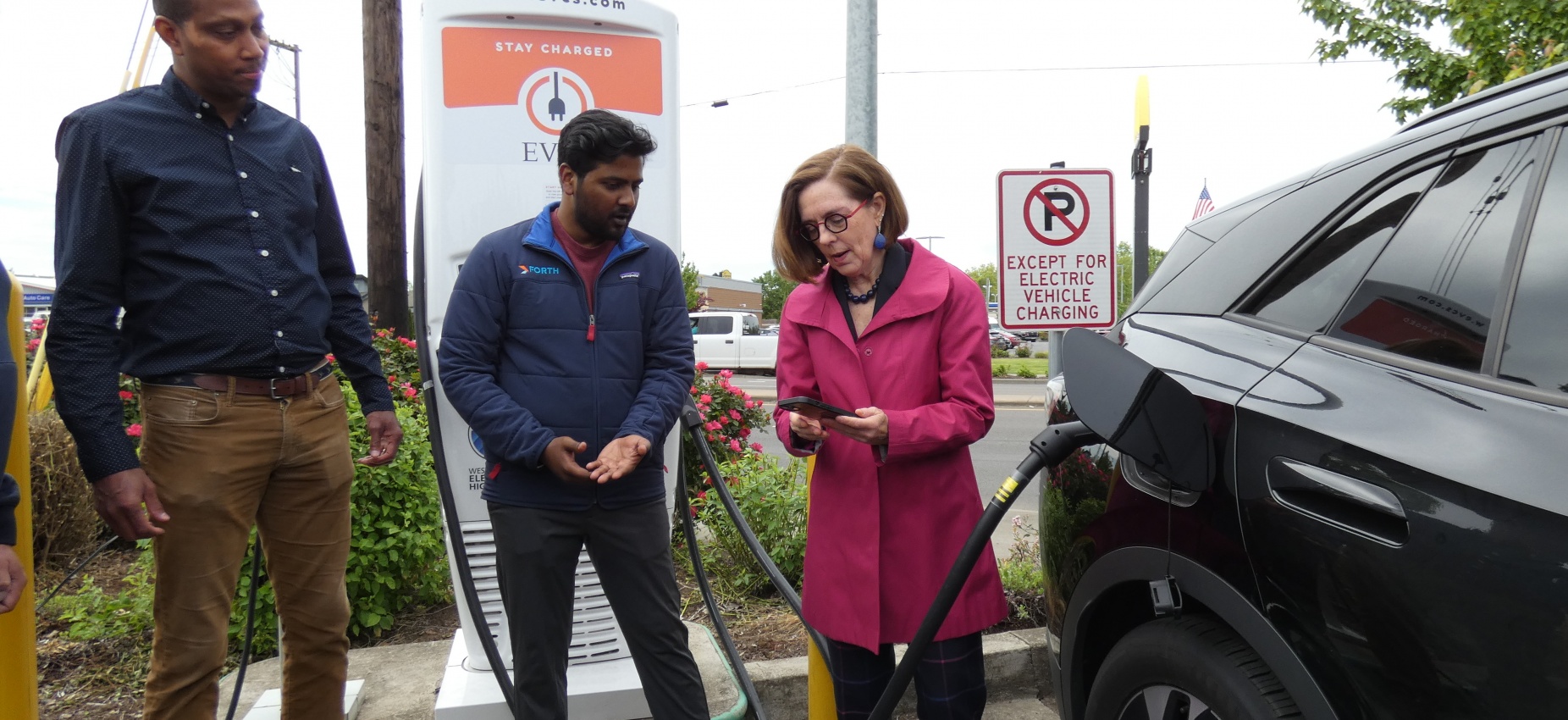 Men of color with Kate Brown at West Coast Highway Charging Station