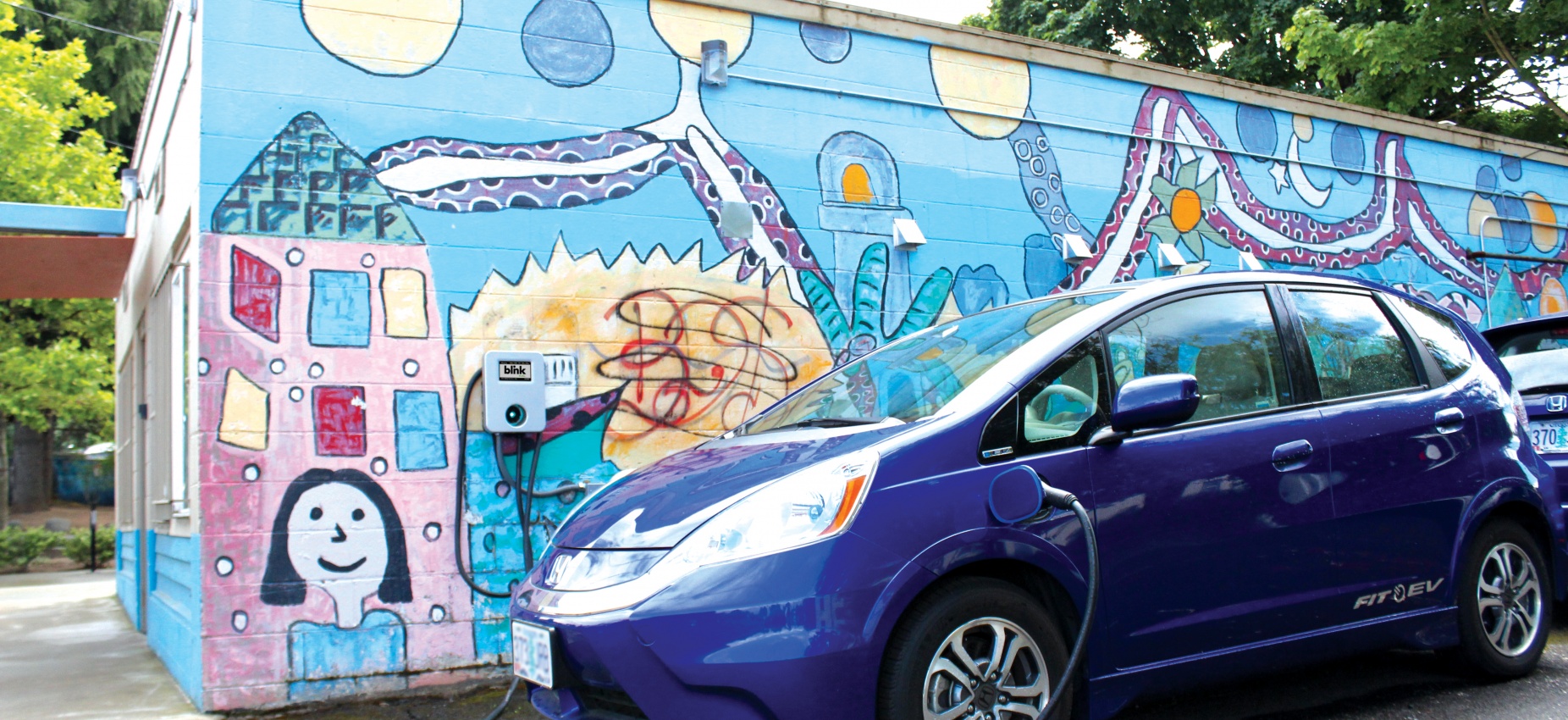 Electric car charging at wall charging port