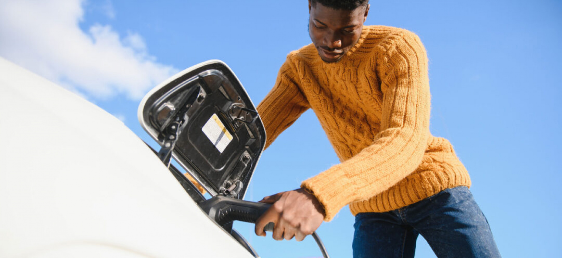 Man of color charging an ev