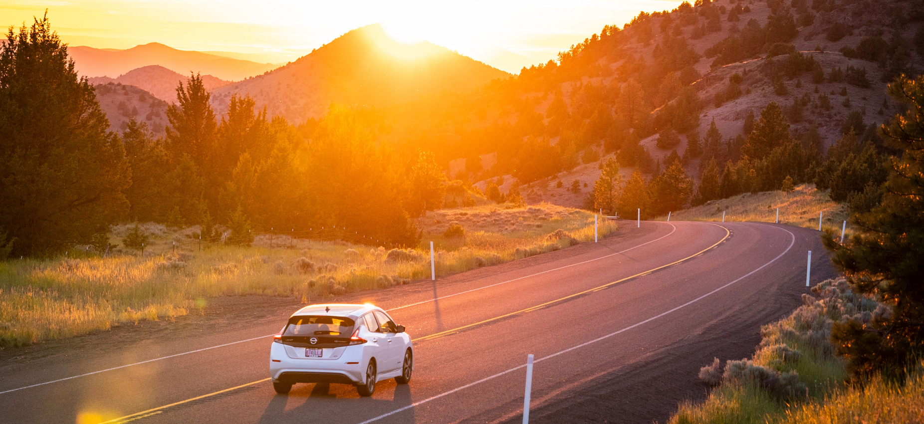 EV on country road in sunset